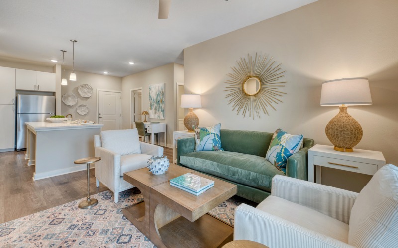 A living room with couches and club chairs